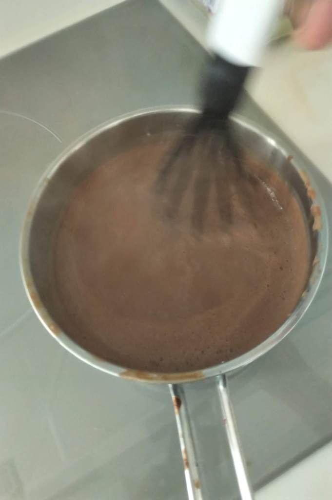 Galltery of making thick hot chocolate in Menorca using the ready mixed powder with flour and sweetener 